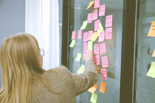 Woman placing post-it notes on the wall