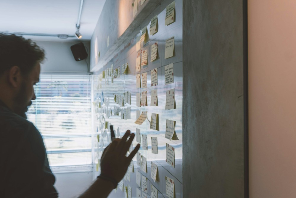 A man pointing at post-it notes