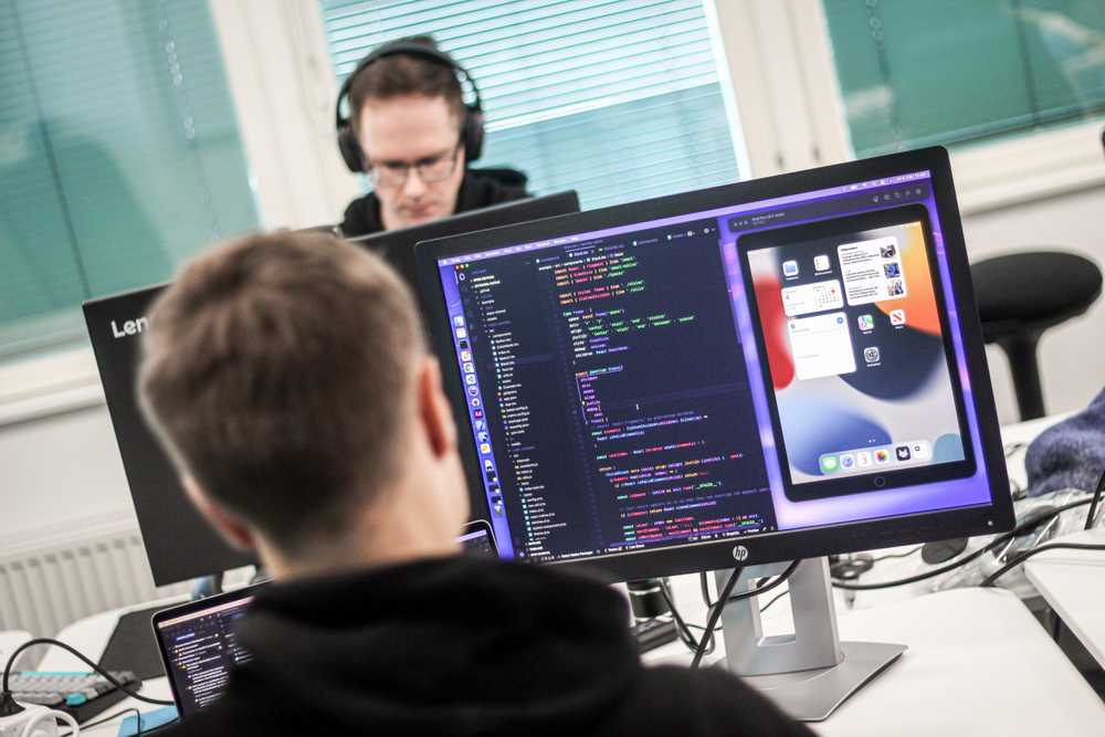 Two men working at their computers