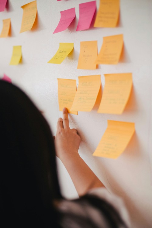 A woman pointing at post-it-notes