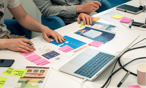 Workshop with post-its and a laptop on the table